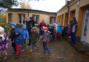 Dzieci pod opieką nauczycielek i personelu opuszczają budynek przedszkolny